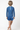 Child wearing a blue patterned rash guard and shorts on a white background