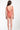 Person wearing a pink swimsuit on a white background