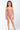 Young girl wearing a pink patterned swimsuit on a white background