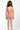 Young girl wearing a pink patterned swimsuit on a white background