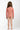 Child wearing a pink patterned bodysuit on a white background