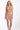 Woman wearing a coral lace lingerie set on a white background