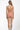 Woman wearing a pink floral one-piece swimsuit on a white background