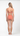 Person wearing a coral swimsuit on a white background