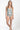 Woman wearing a light green swimsuit with a white background