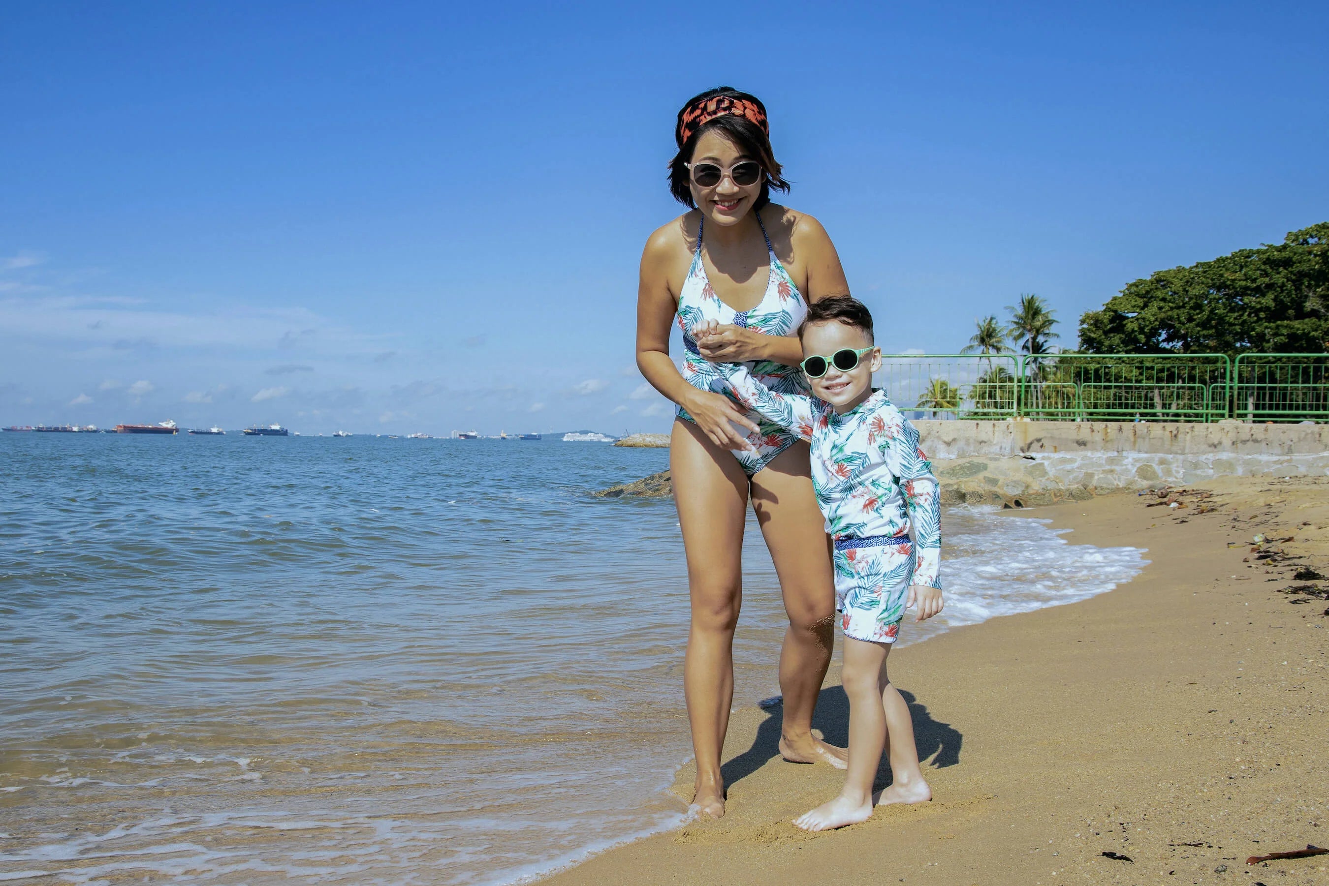 Mother and child wearing matching swimwear with Due South and Blue Hawaiian Tropic print.