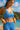 Woman wearing a blue and white patterned swimsuit on a beach