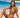 Woman in a bikini sitting on a beach with palm trees and clear blue water in the background