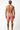 Man wearing red patterned swim shorts on a white background