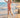 Child in a red swimsuit running on a beach with palm trees in the background