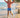 Child playing on a beach with palm trees in the background
